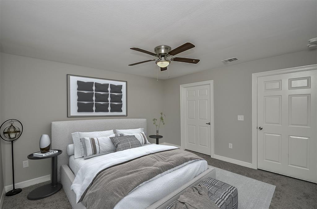 Primary room with grey walls, carpeted floor, and ceiling fan located on the first floor.