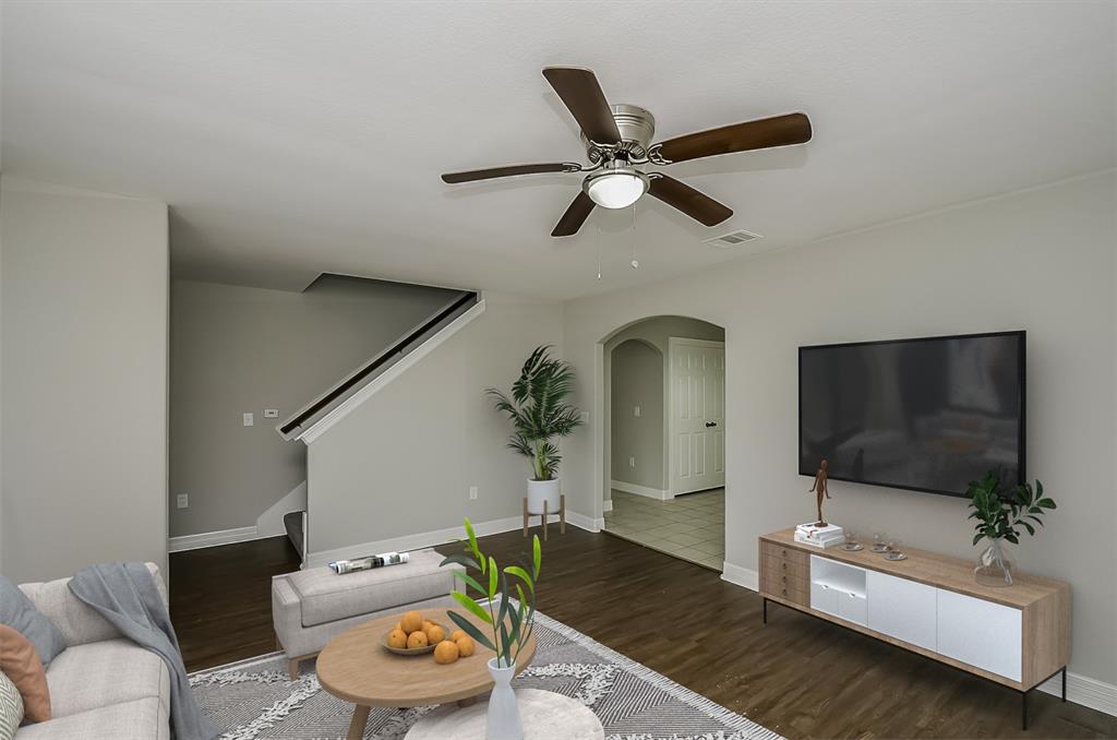 Modern staged living room with a connected dining area and neutral tones.