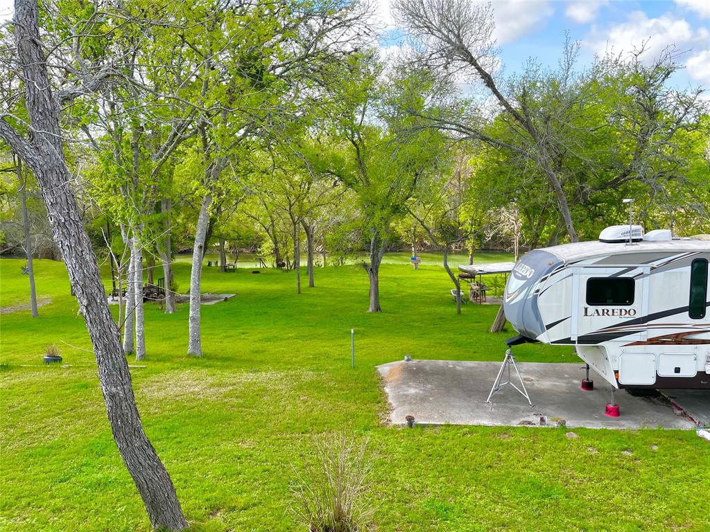 View of property looking out to the river. Concrete pad has electric hook up.