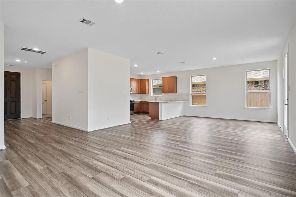 Gather the family and guests together in your lovely living room! Featuring high ceilings, recessed lighting, ceiling fan, custom paint, gorgeous tile floors and large windows that provide plenty of natural lighting throughout the day.