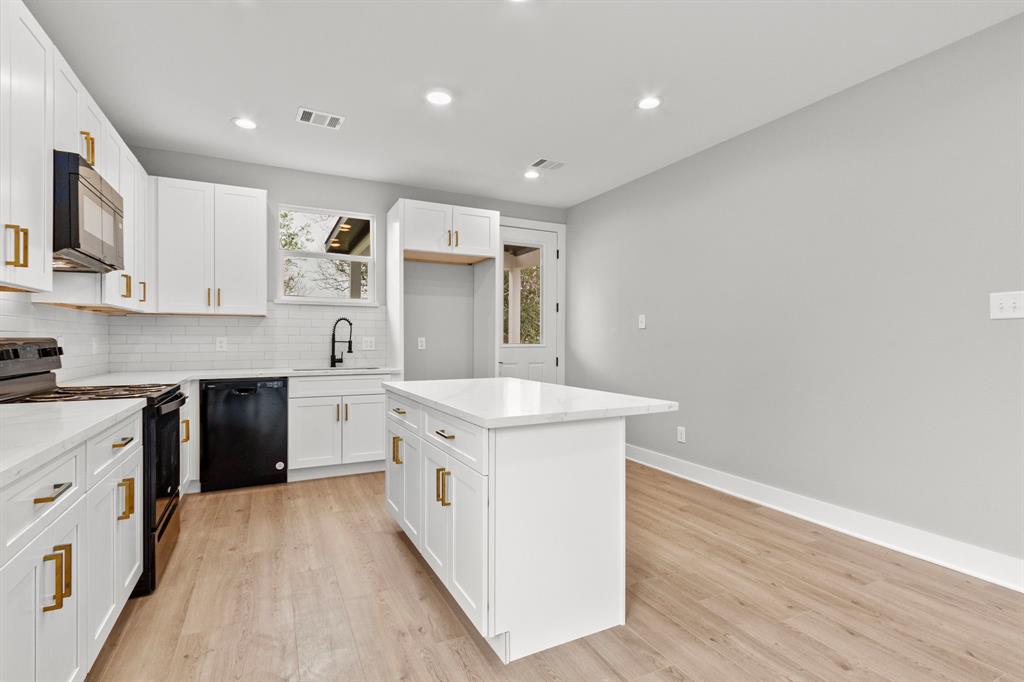 Recessed lighting throughout the open floor layout.