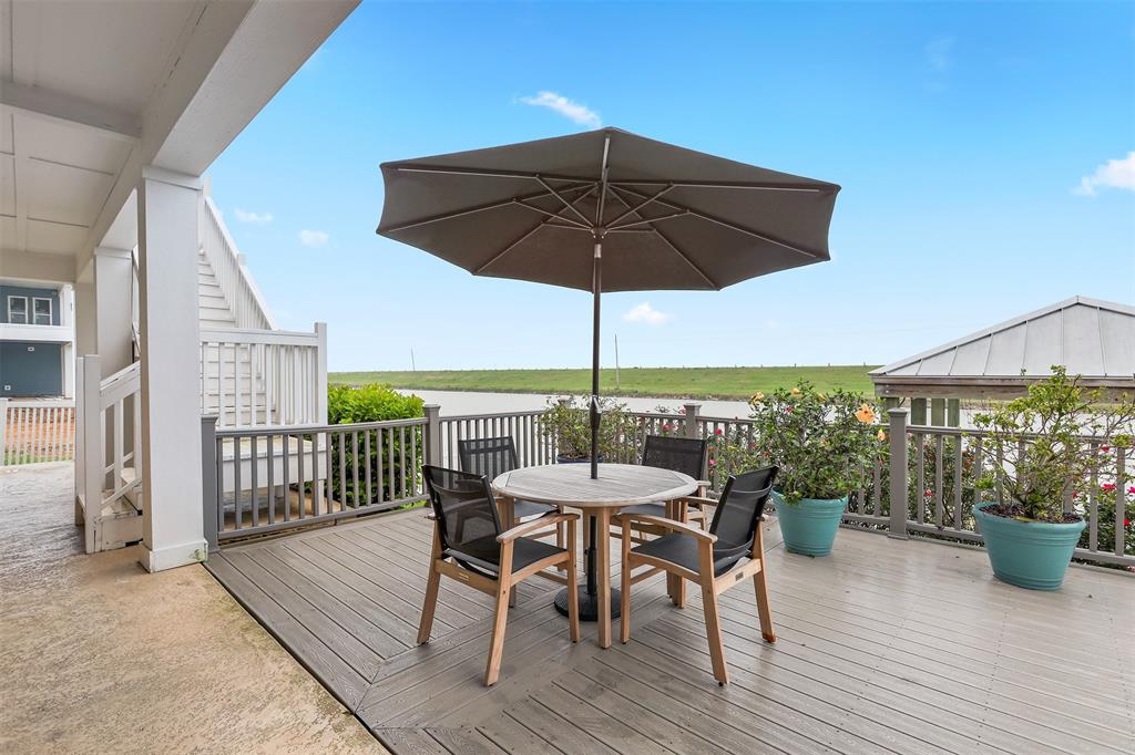 Back covered patio and deck with water views.