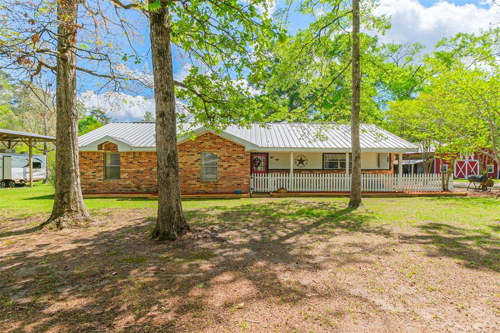 Located in Tarkington ISD this 7.5 acre completely fenced/cross fenced property has everything you need! This 2,000sqft brick home is surrounded by large shade trees and green pastures. The home features 3 bedrooms, 2 bathrooms, two pantry closets, a wood burning fireplace, a large laundry room, a metal roof, two vehicle carport, a large side patio, 263ft deep water well and septic system. Updates include quartz countertops and freshly painted cabinets in the kitchen (2024), a new a/c unit (2022), fresh flowerbeds (2024), and new white pickets along the front porch (2024). This beautiful property also has a 40'X30’ barn with a loft and a leanto on each side, a 20'X18' livestock barn with two stalls and a room to store feed, and a 40'X16'X13' RV carport with its own septic tank, and 50amp hookup. Wash/dryer and refrigerator is included!