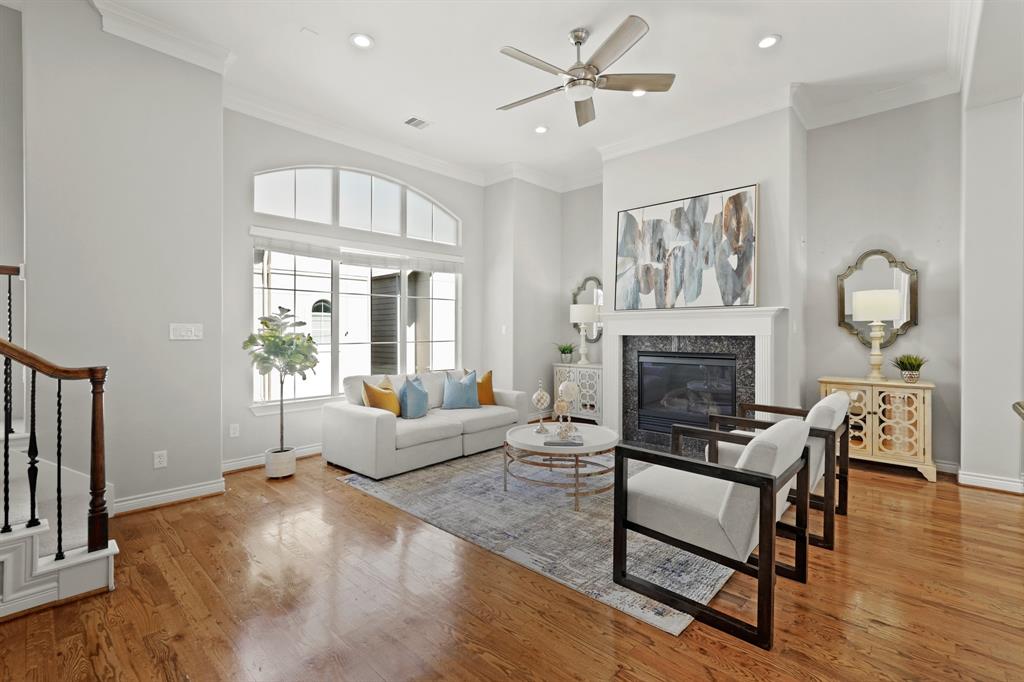 The living room has a gas fireplace and large windows