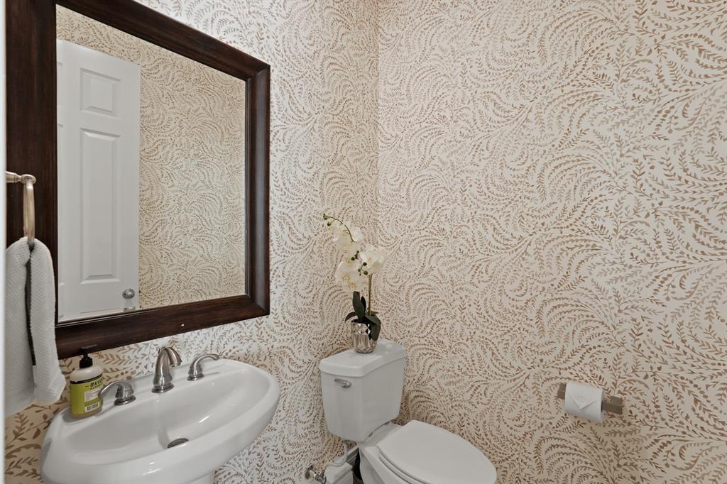 There is a guest half bathroom with new wallpaper on the second floor