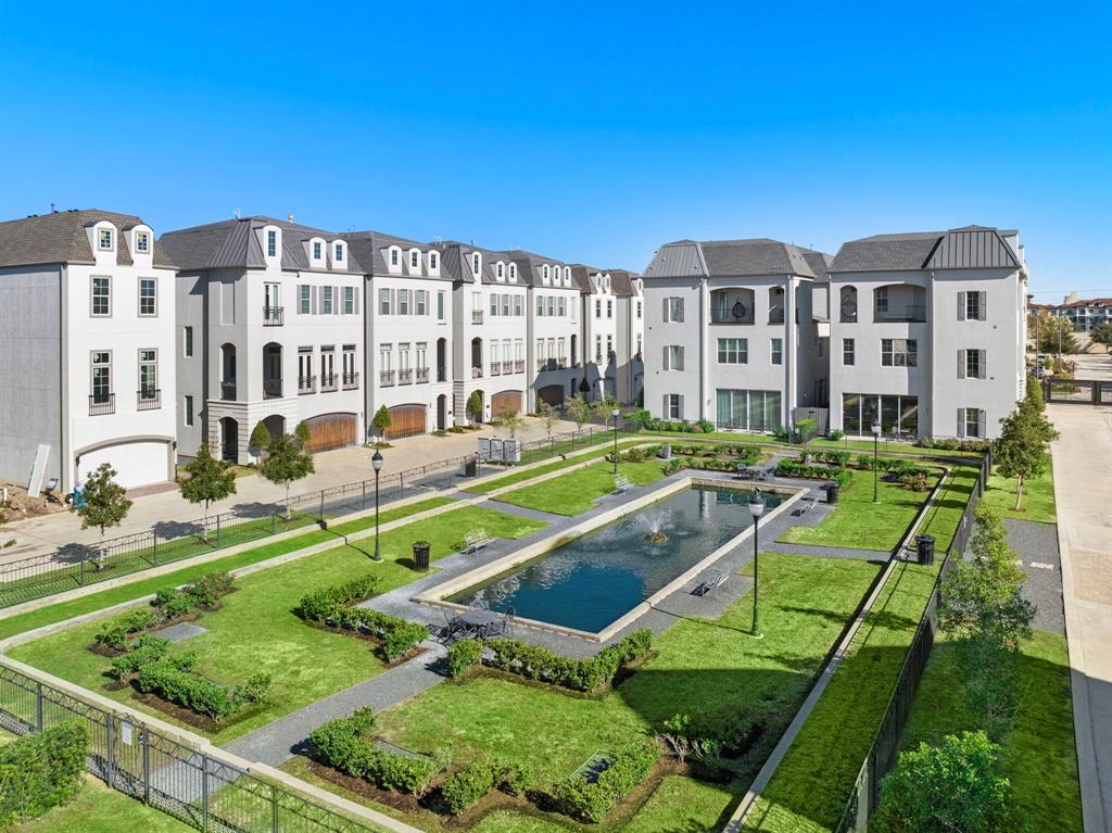 The green space surrounding the man-made pond is fenced and gated. A wonderful space to sit and enjoy some lunch or watch your pet frolic about.