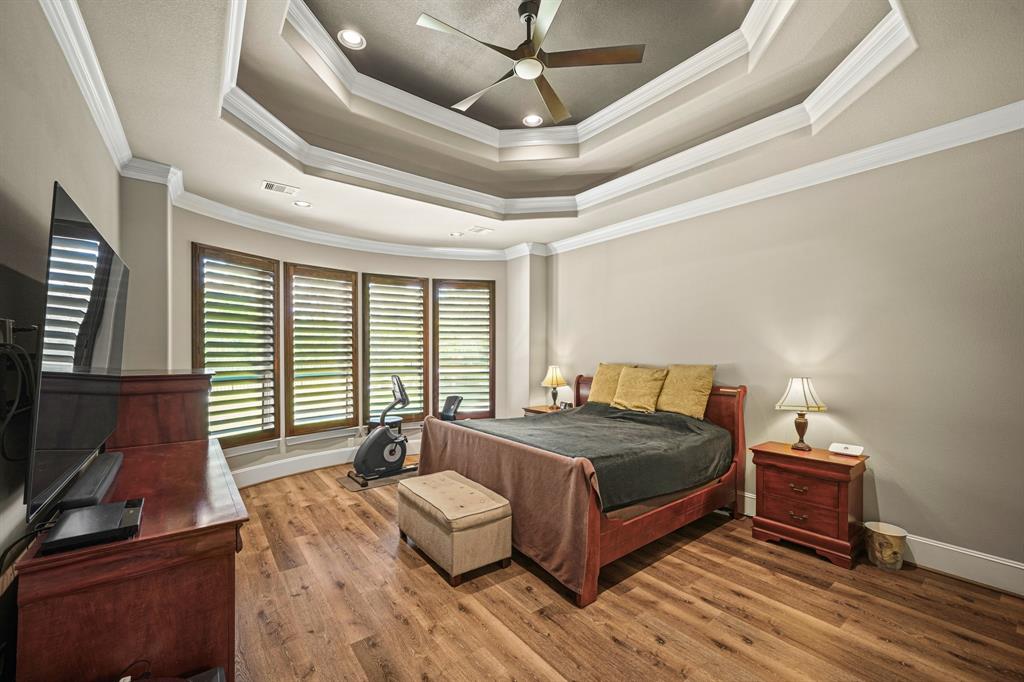 Large primary bedroom with wall of windows overlooking back yard (with NO BACK NEIGHBORS!) :)