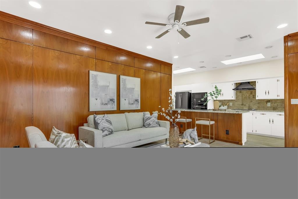 Den open to kitchen.  Tile flooring, ceiling fan