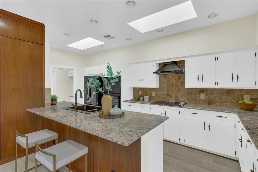 Skylights in kitchen that bring even more light to the kitchen & Den.