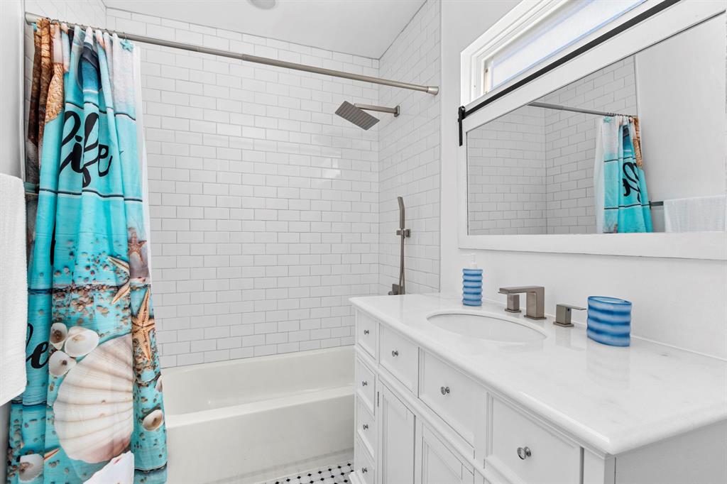 This bath has a tub for bathing littles and trendy white subway tiles. Notice the upgraded rainhead shower and handheld shower sprayers!