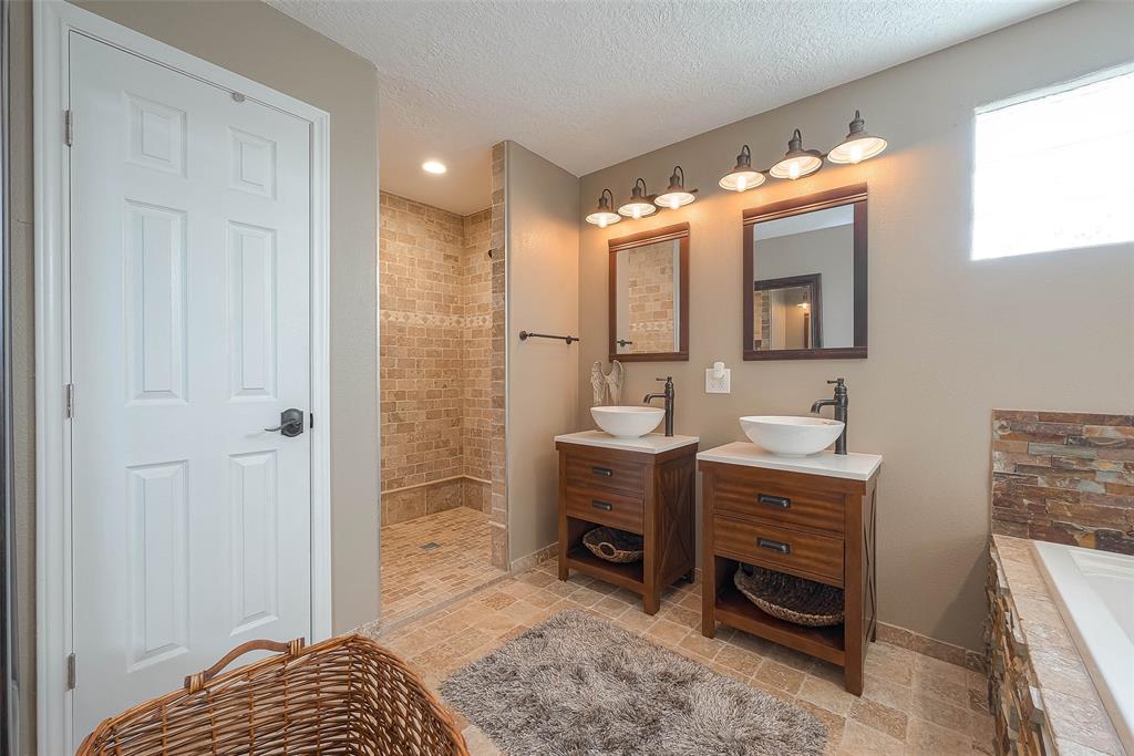 This spa-like primary bathroom is the perfect place to start and end your day. His and hers sinks provide ample space for two to get ready in the morning.