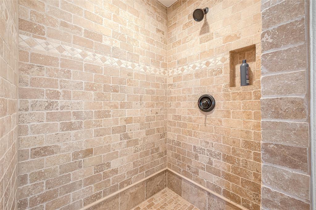 the walk-in shower with floor-to-ceiling tiling invites you to relax and unwind after a long day.