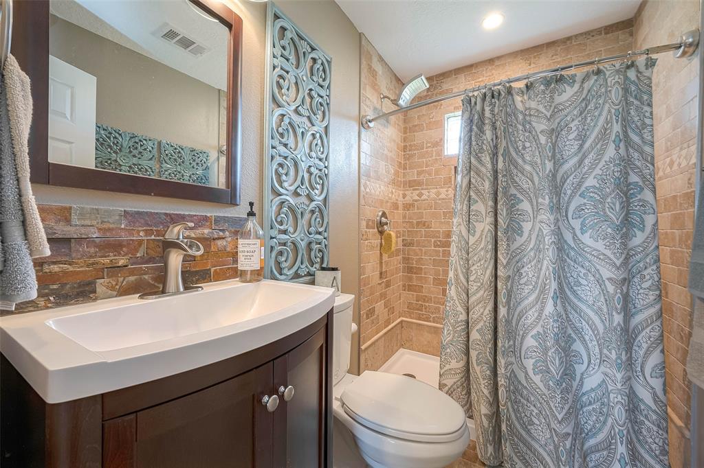 Secondary bathroom with walk-in shower and beautiful stone detailing