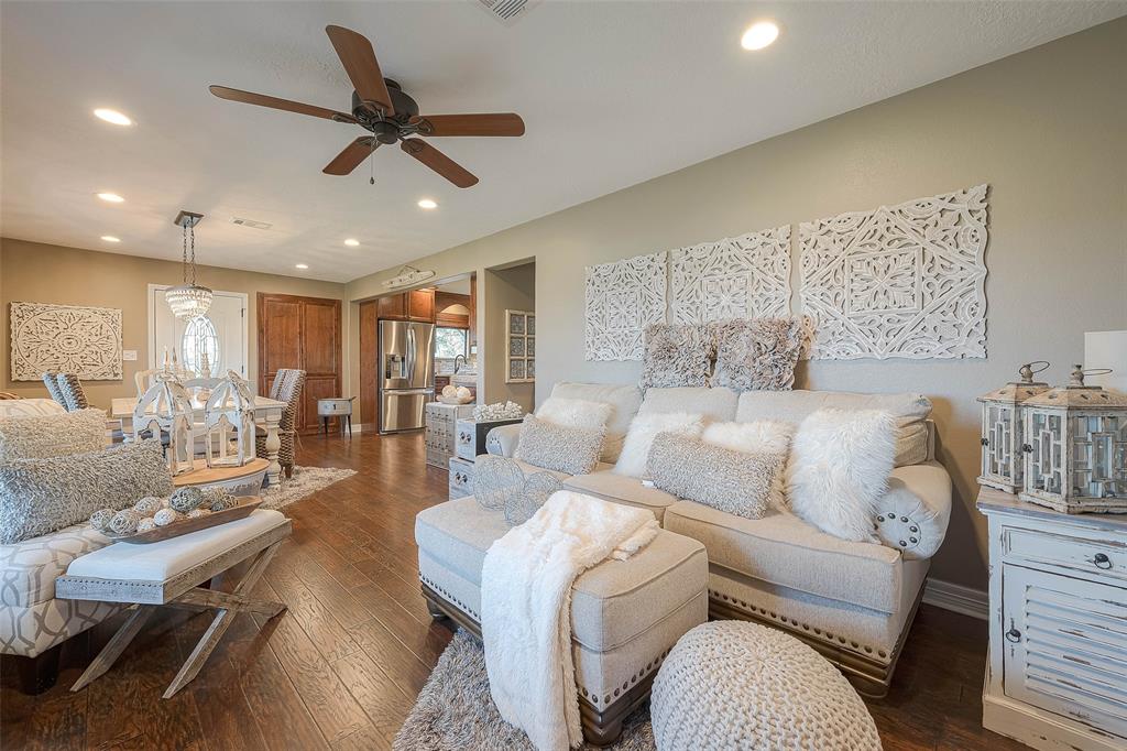 The open floor plan flows seamlessly into the dining room and kitchen. This is the perfect space to relax with family and friends, or to enjoy a quiet evening at home.