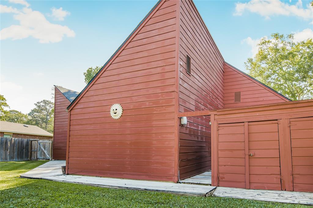 Back of the home with a seperate storage area