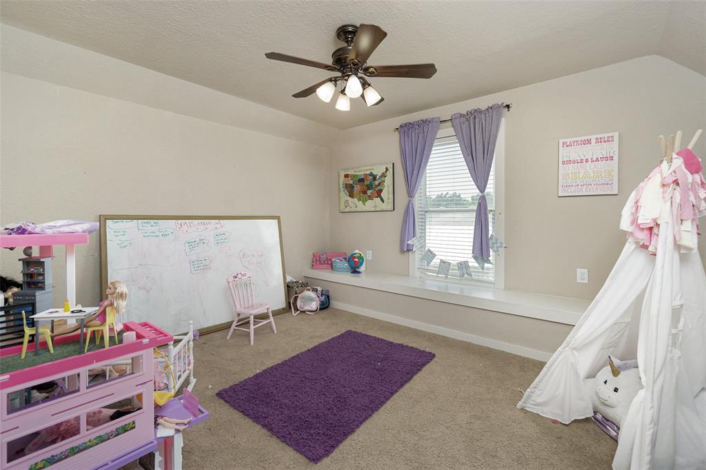 Second bedroom on the second floor with window seat and walk out to attic storage