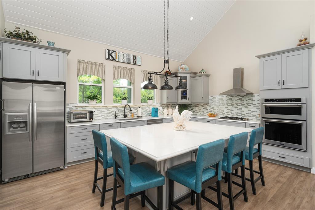 Kitchen with grand island, designer back splash and stainless-steel appliances