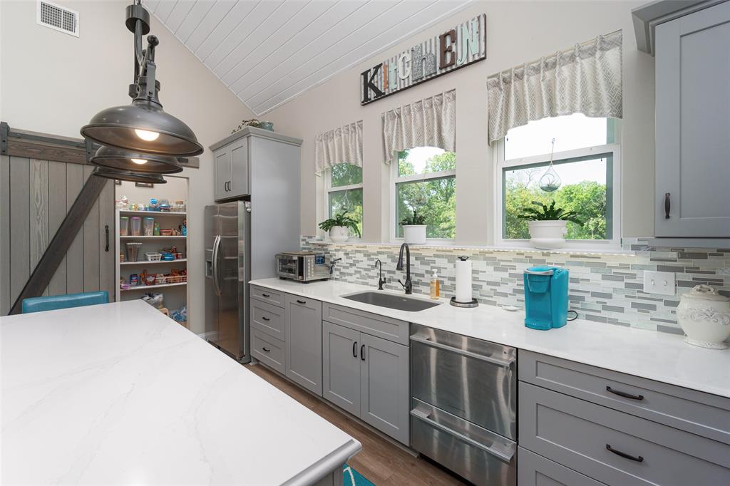 Charming kitchen with windows overlooking the back yard and bayou!