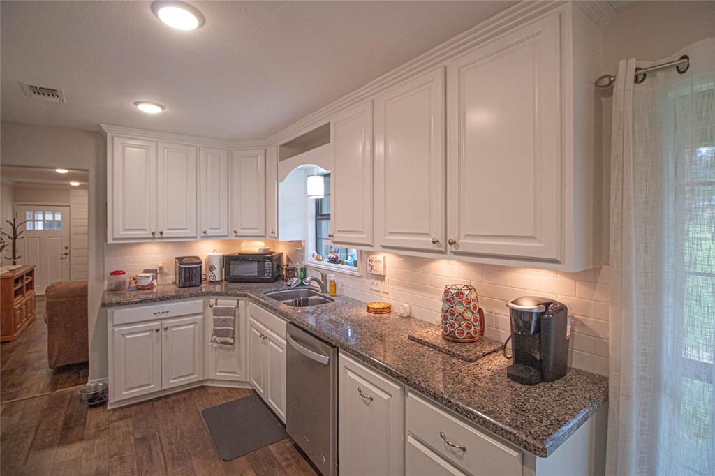 LOTS OF CABINET SPACE IN THIS BRIGHT KITCHEN