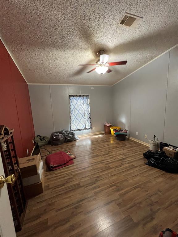 Primary bedroom looking towards walk-in closet and bathroom.