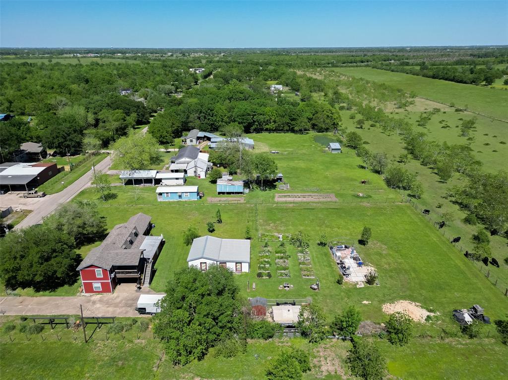 aerial view from the right of the property- property extends to the fence that backs up to the greenbelt