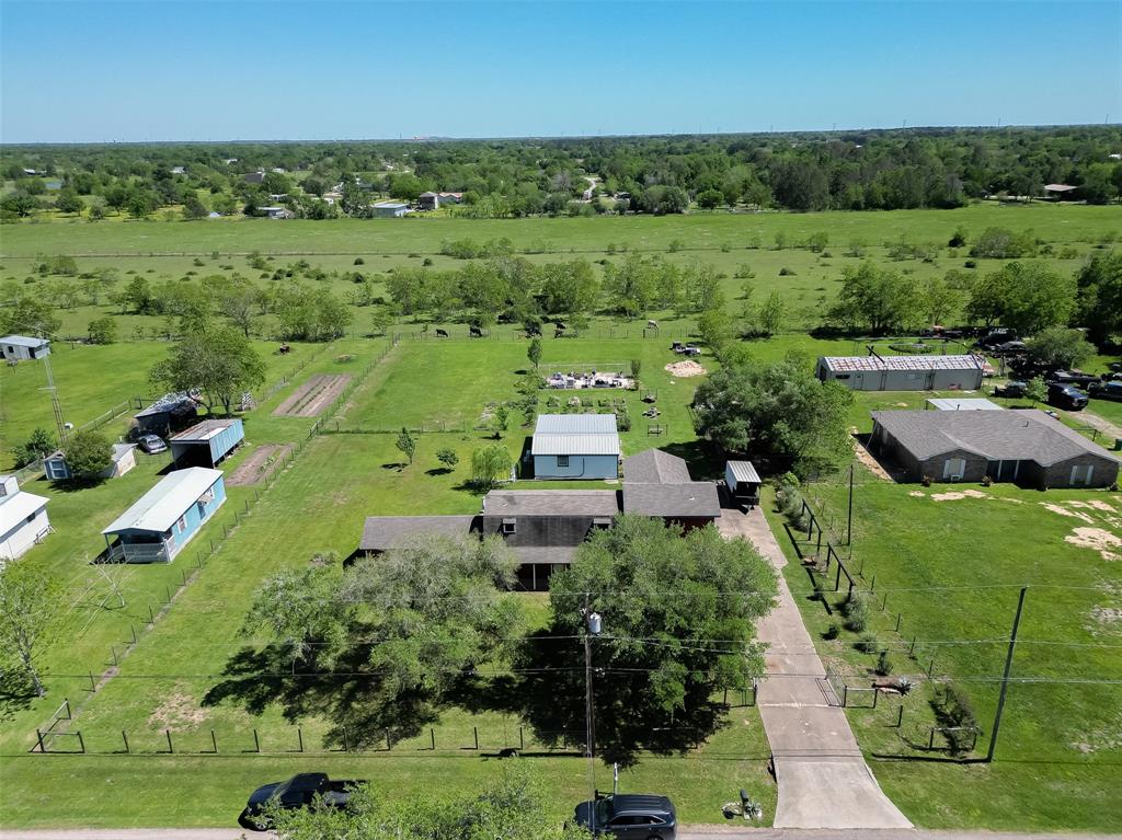 aerial view of the property over an acre of land