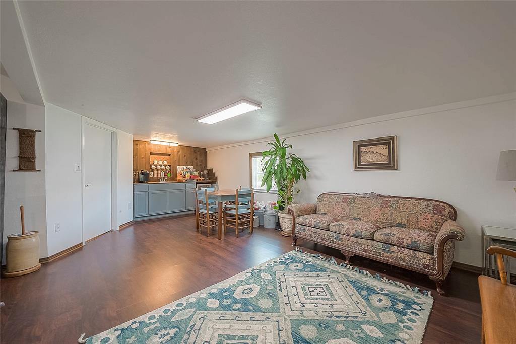 Flexible living spaces on the first floor. This space includes a wet bar, access to utility room and direct access to the carport.