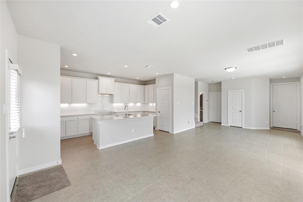 Opposite view from the rear of the home highlights the tucked away kitchen and half bath.