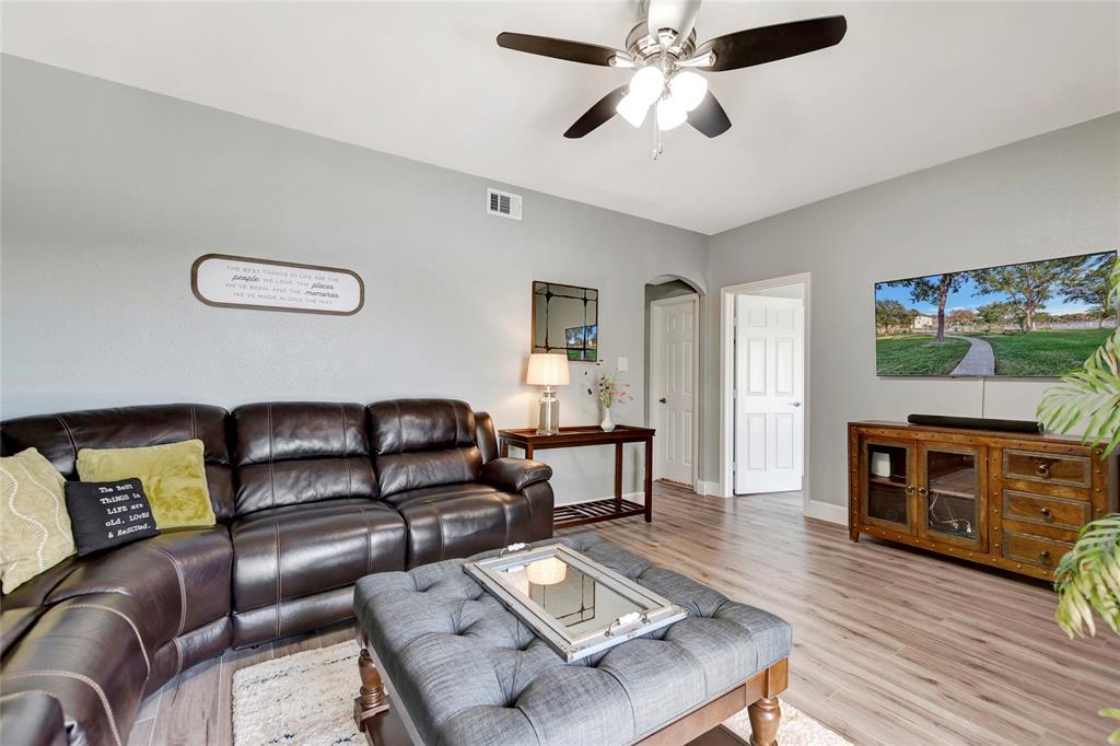 This condo features a thoughtfully designed floor plan and the heart of the living area creates a cozy ambiance. Staged Photo.