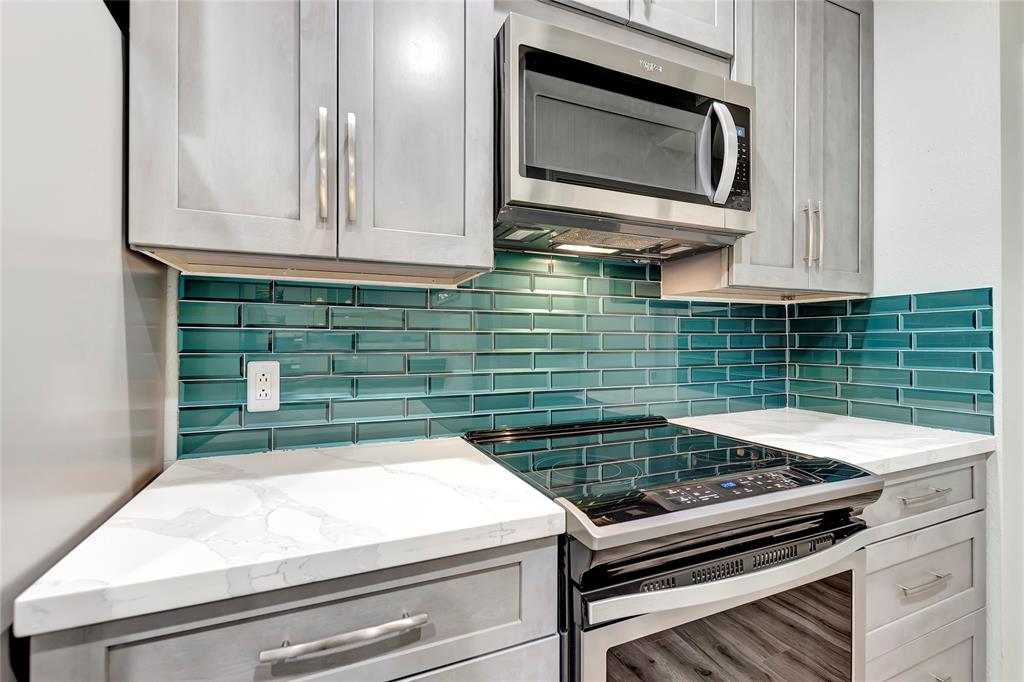 Luxury Beveled Glass Subway Tile Backsplash and Soft-Close Cabinetry that Adds Functionality and Modern Style.