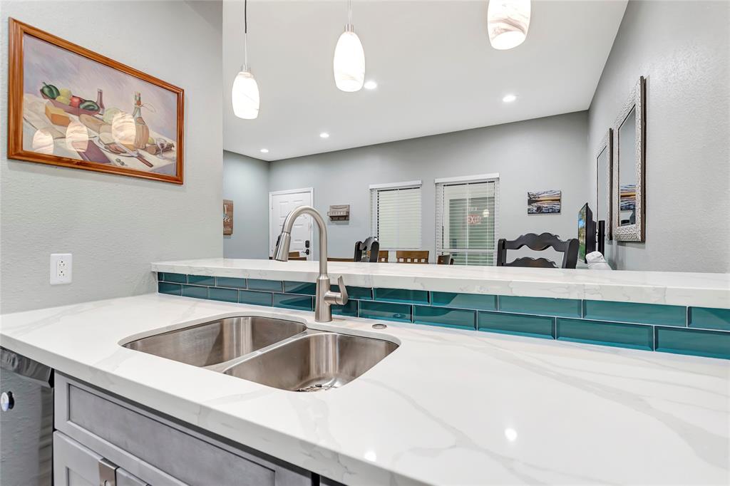 The Kitchen boasts gorgeous Quartz Countertops, Breakfast Bar, and a wide-open view to the Dining Room.