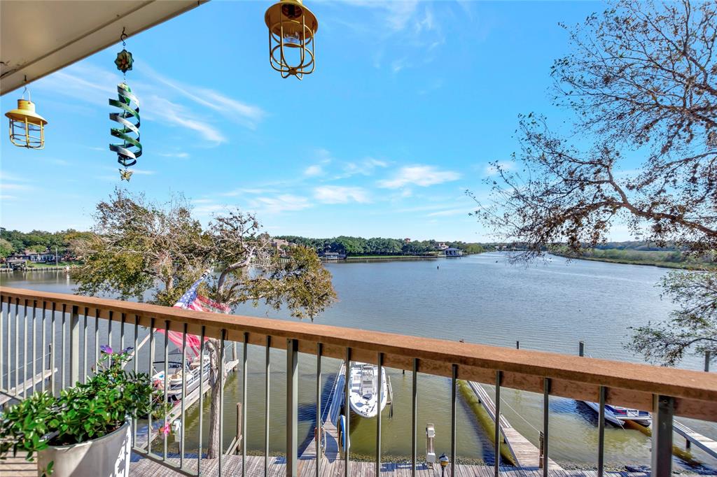 Large Access Triple Pane Hurricane Glass Balcony Doors that allow great waterfront views and natural light to cascade in the Family Room.  Beautiful Wood Burning Fireplace that include 20” Revillusion Electric Insert Log Set Staged Photo.