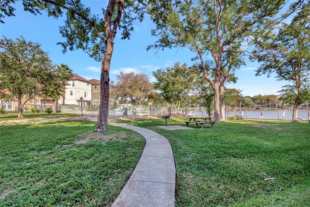 Community Area with picnic tables, lots of trees, green space, and a place to enjoy the tranquil water views.