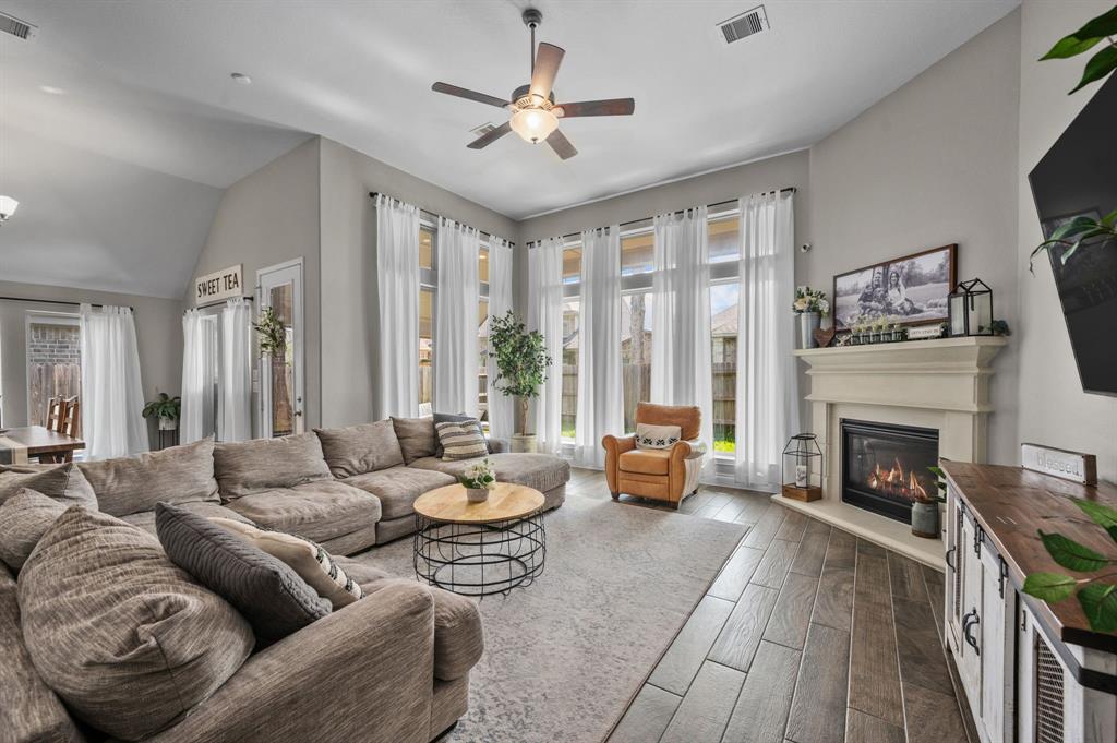 Family Room featuring gas-burning fireplace and large windows.