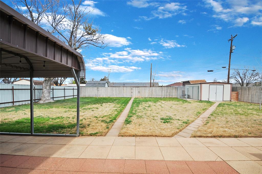 Huge patio overlooks this great fenced backyard