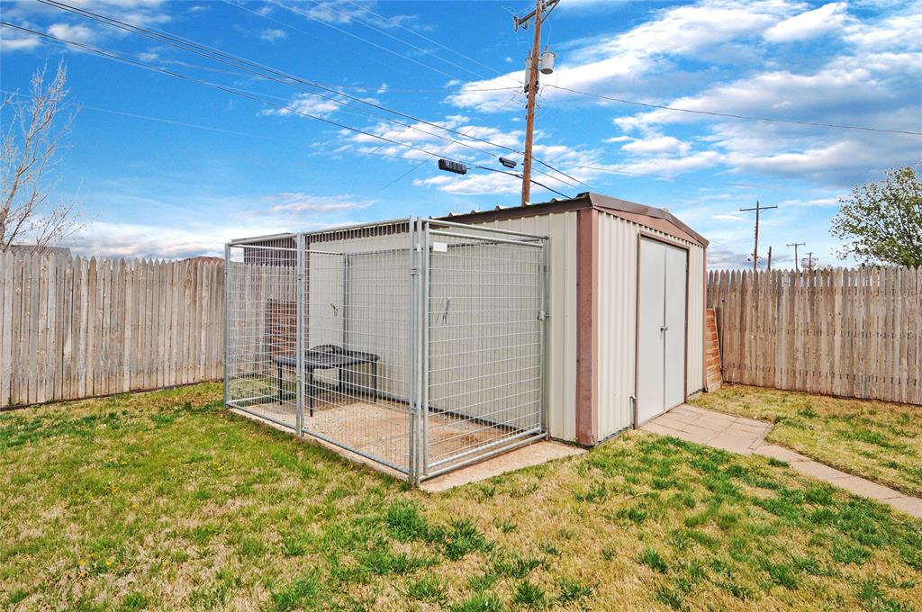 Storage shed for your lawn equipment... and first class kennel