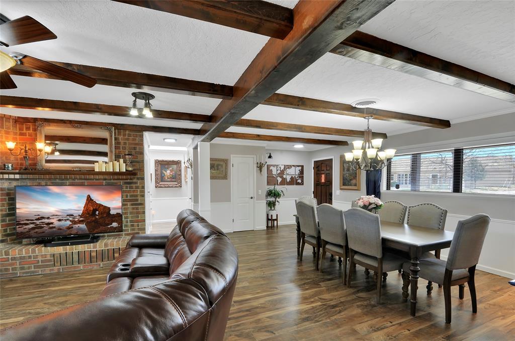 Wood beams on the ceiling add a nice touch.  Notice the crown molding and chair railing, as well as the beautiful luxury vinyl plank flooring