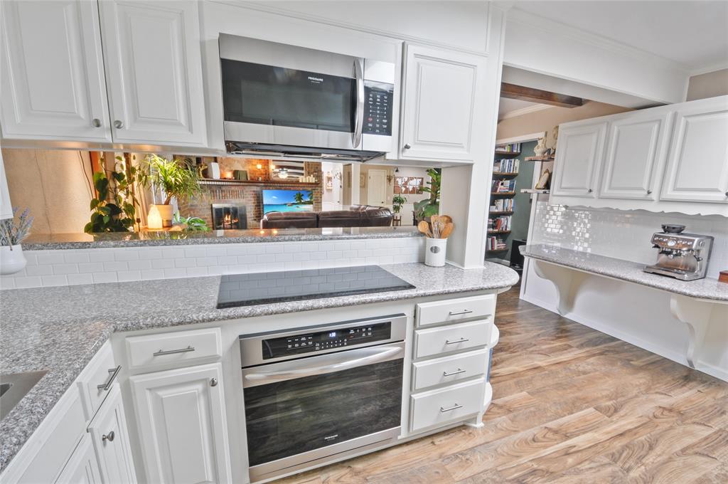 Modern updated electric oven and electric cooktop.  Built-in microwave/vent hood above.  Lots of cabinet storage and drawers