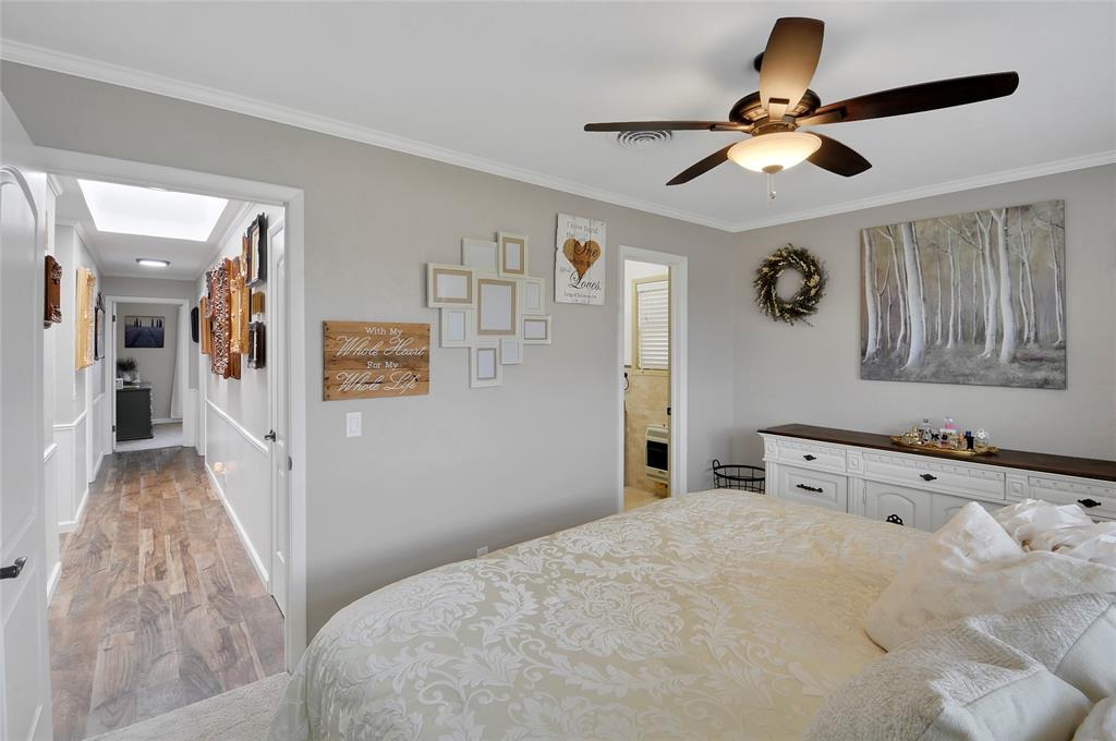 Primary bedroom located off main hallway.  Luxury lighted ceiling fan.