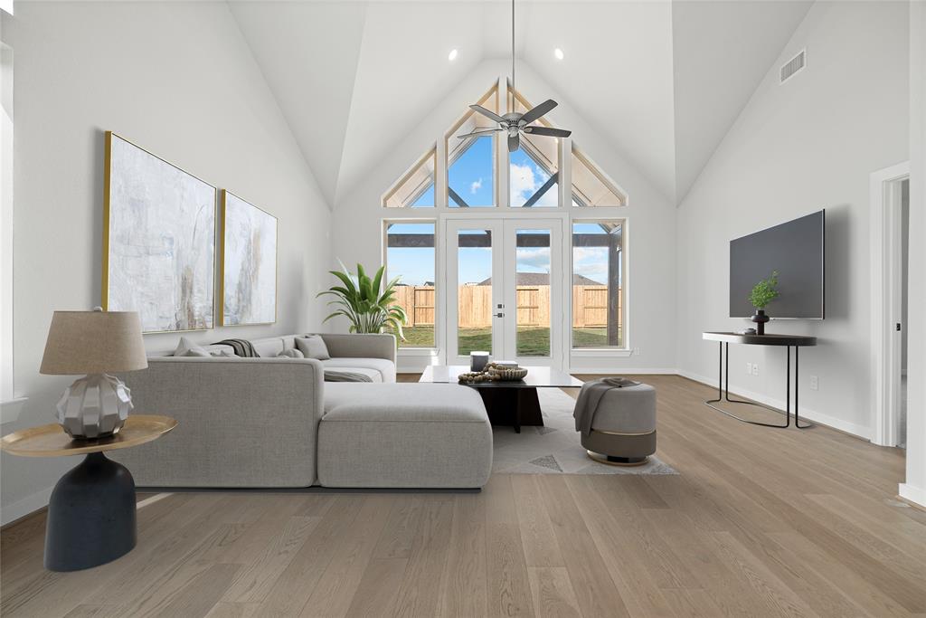 The gorgeous point vaulted ceiling elevates the Family Room with oversized windows allowing for plenty of natural light.