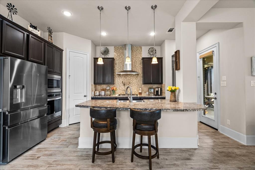 Kitchen features a convenient pot filler behind the cooktop