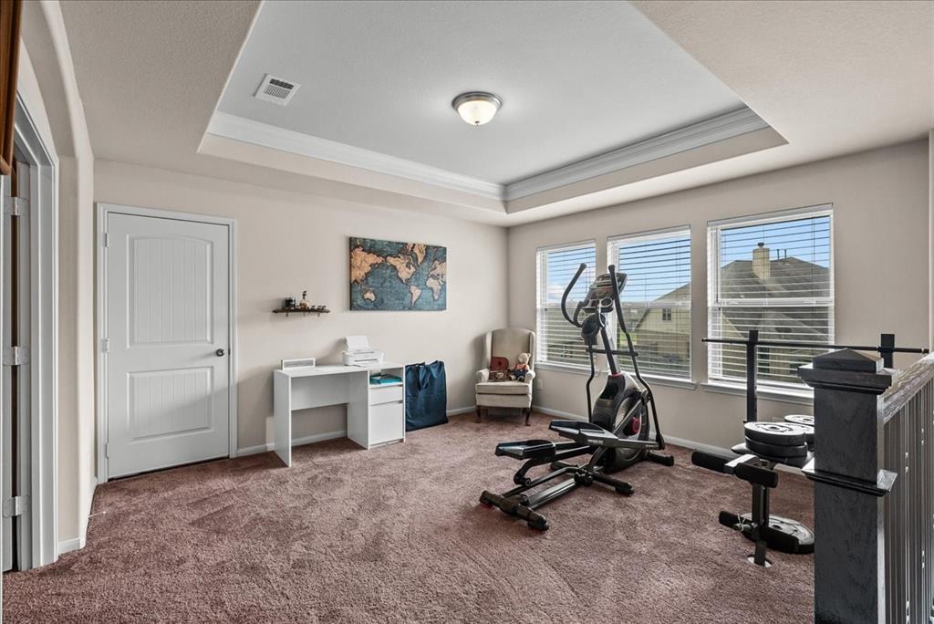 Media Room with adjustable lighting and tray ceiling, located on the second floor.  TV conveys with the house