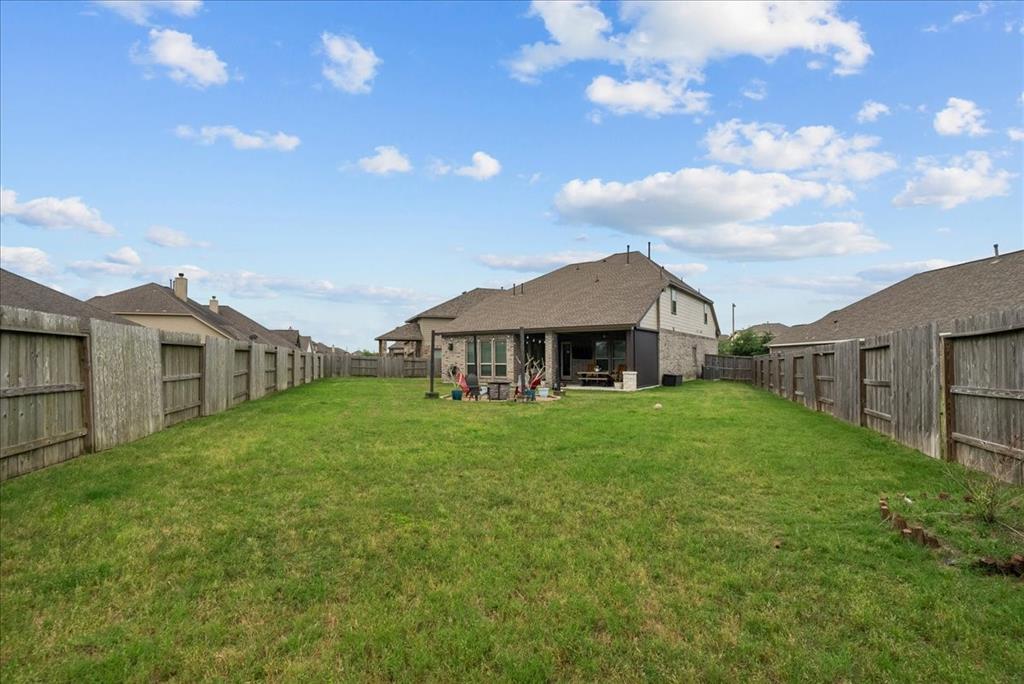 Custom back patio, complete with ceiling fan, sun shade and tv, which conveys with house