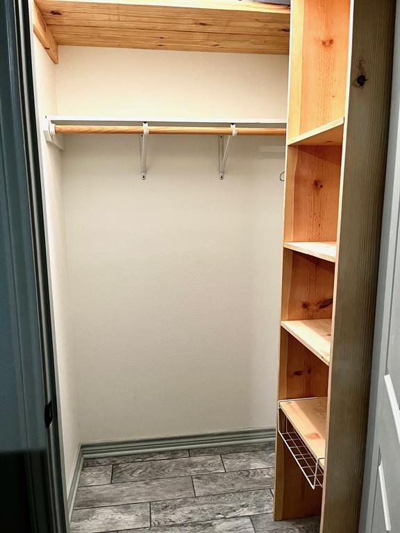 The closet is nicely sized with shelves for extra storage space.