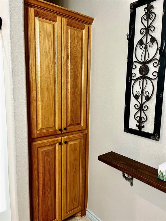 The guest bath features cabinets for lots of storage space.