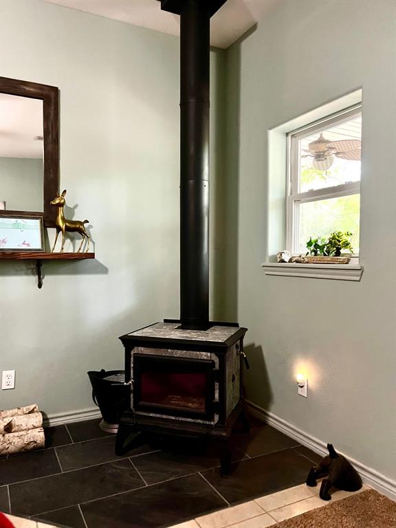 The living room is huge and has a wood burning fireplace in the corner.