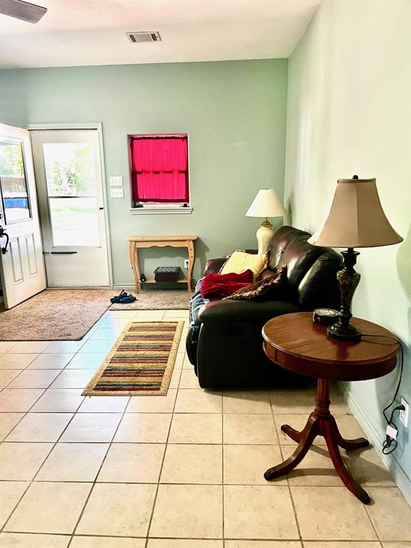 The living room is huge and has a wood burning fireplace in the corner.