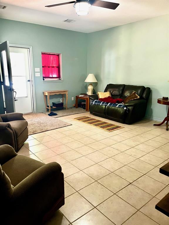 The living room is huge and has a wood burning fireplace in the corner.