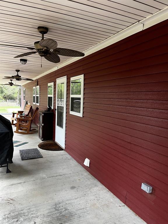 The back porch with 3 ceiling fans to keep you comfortable in the hot Texas heat.