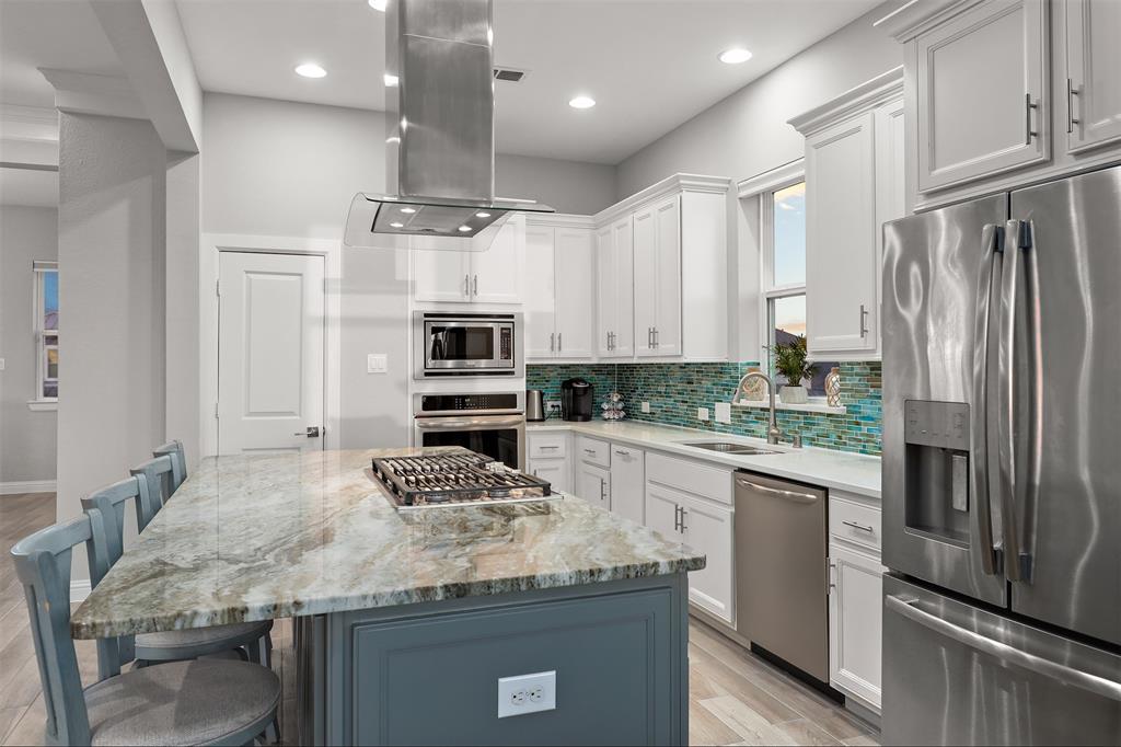 Kitchen island has custom granite.